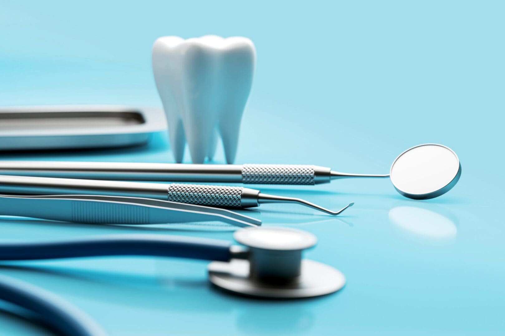 Dental instruments and tooth model on blue